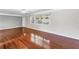 Open-concept living area with hardwood floors, neutral paint, and ample natural light at 5947 46Th N Ave, Kenneth City, FL 33709