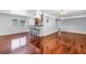 Open-concept living and dining area with hardwood floors, featuring a breakfast bar with seating at 5947 46Th N Ave, Kenneth City, FL 33709