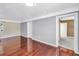 Spacious living room features pristine walls, beautiful hard wood floors and a modern lighting fixture at 5947 46Th N Ave, Kenneth City, FL 33709