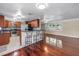 Open-concept living and dining area featuring a breakfast bar with stools and updated kitchen at 5947 46Th N Ave, Kenneth City, FL 33709