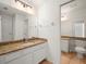 Bathroom featuring a large mirror, tile floors, granite countertops and white cabinets at 6127 Cezanne Ave, Lutz, FL 33558