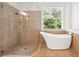 Bright bathroom with glass shower and freestanding tub at 6127 Cezanne Ave, Lutz, FL 33558