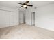 Bedroom with a ceiling fan, closet with folding doors and doorways leading to other rooms at 6127 Cezanne Ave, Lutz, FL 33558