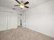 Bedroom with ceiling fan, closet with folding doors and doorways leading to other rooms at 6127 Cezanne Ave, Lutz, FL 33558