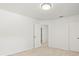 Bright bedroom featuring neutral carpet, white walls and trim and two doors to other rooms at 6127 Cezanne Ave, Lutz, FL 33558