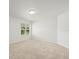 Bright, carpeted bedroom with a standard light fixture and window bringing in ample natural light at 6127 Cezanne Ave, Lutz, FL 33558