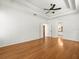 Large bedroom with tray ceiling, wood floors, and ensuite bathroom at 6127 Cezanne Ave, Lutz, FL 33558