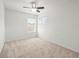 This is a bright bedroom with neutral carpet and dual windows bringing in natural light at 6127 Cezanne Ave, Lutz, FL 33558
