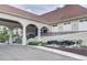 Clubhouse exterior with elegant arches, water feature, and manicured landscaping at 6127 Cezanne Ave, Lutz, FL 33558
