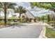 Elegant gated community entrance with stone accents, lush landscaping, and a private entry road at 6127 Cezanne Ave, Lutz, FL 33558