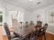Inviting dining room featuring a large wooden table, ideal for Gathering meals and entertaining at 6127 Cezanne Ave, Lutz, FL 33558