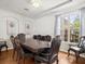 Formal dining room with a large window, hardwood floors, chandelier, and stylish furnishings for elegant dining experiences at 6127 Cezanne Ave, Lutz, FL 33558