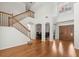 Grand foyer with soaring ceilings, wooden staircase, and elegant front door at 6127 Cezanne Ave, Lutz, FL 33558