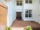 Spacious foyer with high ceilings, brick flooring, and a large front door, creating an inviting entrance to the home at 6127 Cezanne Ave, Lutz, FL 33558