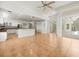 An open concept kitchen with white cabinets, stainless appliances, and a breakfast bar at 6127 Cezanne Ave, Lutz, FL 33558
