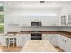 Modern kitchen featuring white cabinetry, stainless steel appliances, and a functional layout at 6127 Cezanne Ave, Lutz, FL 33558