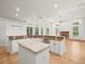 A kitchen featuring white cabinets, stainless steel appliances and a center island at 6127 Cezanne Ave, Lutz, FL 33558