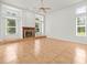 A living room featuring a fireplace and large windows at 6127 Cezanne Ave, Lutz, FL 33558