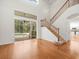 Bright living room with a staircase and access to the outdoor pool and patio area at 6127 Cezanne Ave, Lutz, FL 33558