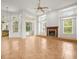 A spacious living room featuring a fireplace and large windows at 6127 Cezanne Ave, Lutz, FL 33558