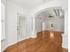 Open living room with tray ceiling, wood floors, and access to the backyard at 6127 Cezanne Ave, Lutz, FL 33558