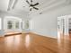 Spacious living room with tray ceiling, wood floors, and ample natural light at 6127 Cezanne Ave, Lutz, FL 33558
