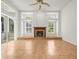 A living room featuring a fireplace and large windows at 6127 Cezanne Ave, Lutz, FL 33558