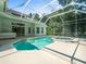 Beautiful, screened-in pool and spa with view of the home's exterior at 6127 Cezanne Ave, Lutz, FL 33558