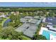 Aerial view of multiple tennis courts next to the pool and lush landscaping at 6127 Cezanne Ave, Lutz, FL 33558