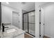 Elegant bathroom with double vanity, granite countertops, and a glass-enclosed shower with tile surround at 6260 Pinehurst Dr, Spring Hill, FL 34606