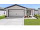 Charming single-story home with a two-car garage, manicured lawn, and welcoming front entrance at 6260 Pinehurst Dr, Spring Hill, FL 34606