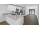 Bright kitchen with granite countertops, stainless steel appliances, and a sliding door to the backyard at 6260 Pinehurst Dr, Spring Hill, FL 34606
