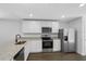 Modern kitchen featuring stainless steel appliances, granite countertops, and ample cabinet space for storage at 6260 Pinehurst Dr, Spring Hill, FL 34606