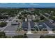 Aerial view of a residential community with townhouses surrounded by lush green trees and a distant bay at 6619 S Manhattan Ave # 1, Tampa, FL 33616
