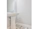 Stylish pedestal sink in bathroom with patterned floor tiles and a large mirror at 6619 S Manhattan Ave # 1, Tampa, FL 33616