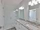 Bright bathroom with double sinks, granite countertops, subway tile shower, and modern fixtures at 6619 S Manhattan Ave # 1, Tampa, FL 33616