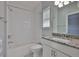 Bright white bathroom with subway tile, granite countertop, decorative floors and modern fixtures at 6619 S Manhattan Ave # 1, Tampa, FL 33616