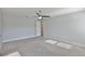 Spacious bedroom features soft carpet, light grey walls, ceiling fan, and ensuite bath at 6619 S Manhattan Ave # 1, Tampa, FL 33616