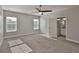 Bright bedroom with neutral walls, carpet floors, ceiling fan, and ensuite bathroom access at 6619 S Manhattan Ave # 1, Tampa, FL 33616
