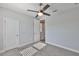 Bedroom features a ceiling fan, carpet, and two doors; one to hallway and one to ensuite bath at 6619 S Manhattan Ave # 1, Tampa, FL 33616