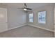 Well-lit bedroom featuring carpet, neutral walls, and two large windows offering natural light at 6619 S Manhattan Ave # 1, Tampa, FL 33616