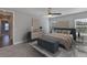 This primary bedroom offers great natural light, a ceiling fan, and an ensuite bath at 6619 S Manhattan Ave # 1, Tampa, FL 33616