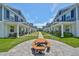 Townhouses with inviting front porches surround a picnic table and well-kept green space for residents to enjoy outdoor activities at 6619 S Manhattan Ave # 1, Tampa, FL 33616