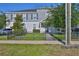 Charming two-story home with gray siding, complemented by a wrought iron fence and landscaped yard at 6619 S Manhattan Ave # 1, Tampa, FL 33616
