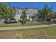 Charming two-story home with gray siding, complemented by a wrought iron fence and landscaped yard at 6619 S Manhattan Ave # 1, Tampa, FL 33616