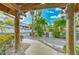 Outdoor marina area featuring white gravel, concrete walkways, lush landscaping, boat, and covered structure at 6619 S Manhattan Ave # 1, Tampa, FL 33616