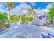 Marina area featuring white gravel, concrete walkways, lush landscaping, lounge chairs, and Southern Cross boat at 6619 S Manhattan Ave # 1, Tampa, FL 33616