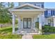 A welcoming front porch with double doors adorned with festive wreaths offers a charming entrance to this lovely townhouse at 6619 S Manhattan Ave # 1, Tampa, FL 33616