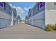 A view of the garages between townhouses under a beautiful sky offers ample parking and storage for residents at 6619 S Manhattan Ave # 1, Tampa, FL 33616