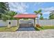 Outdoor grill station featuring a red roof, gray cabinets, stone patio, and lush landscaping at 6619 S Manhattan Ave # 1, Tampa, FL 33616